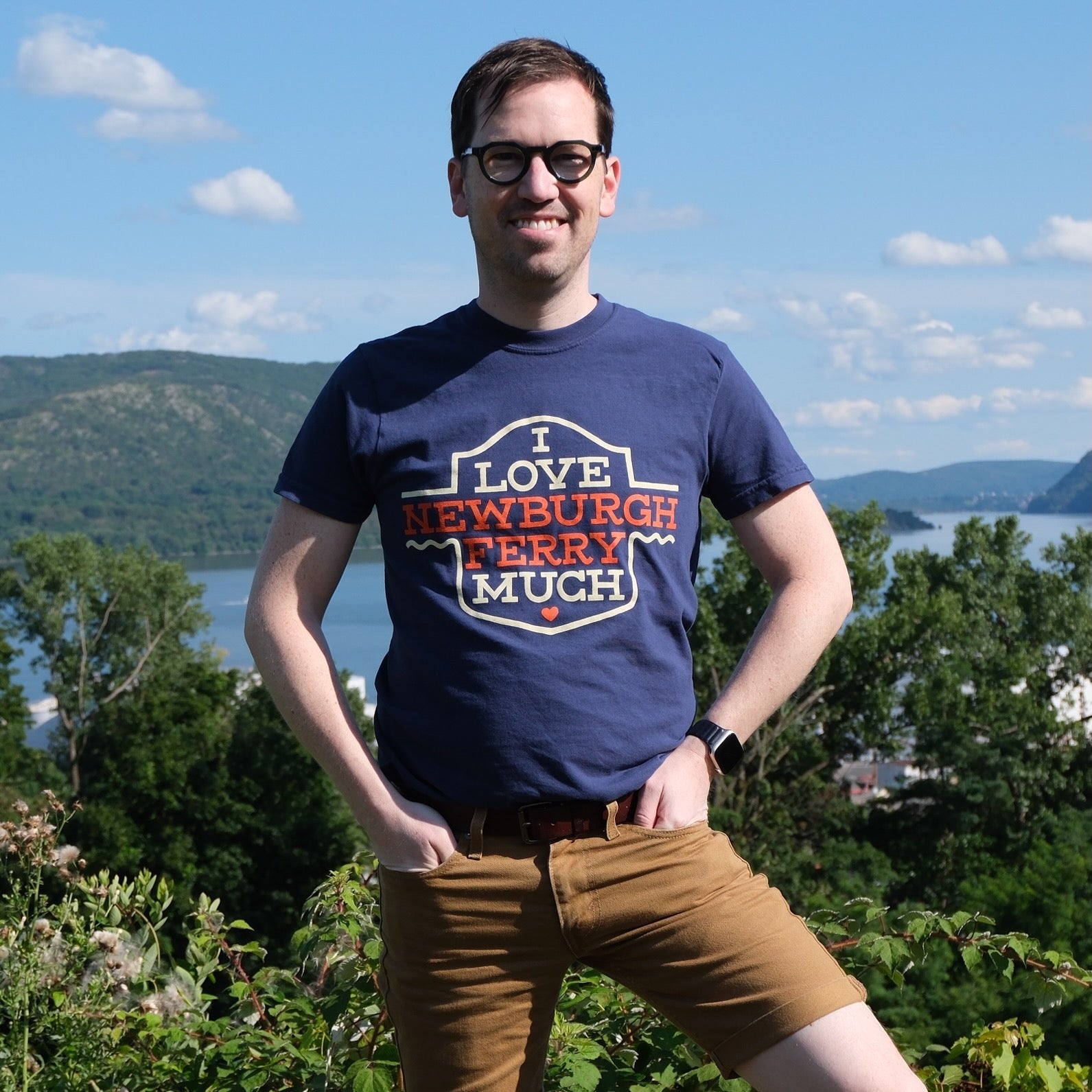 A portrait of Jedd wearing a blue t-shirt that reads I Love Newburgh Ferry Much