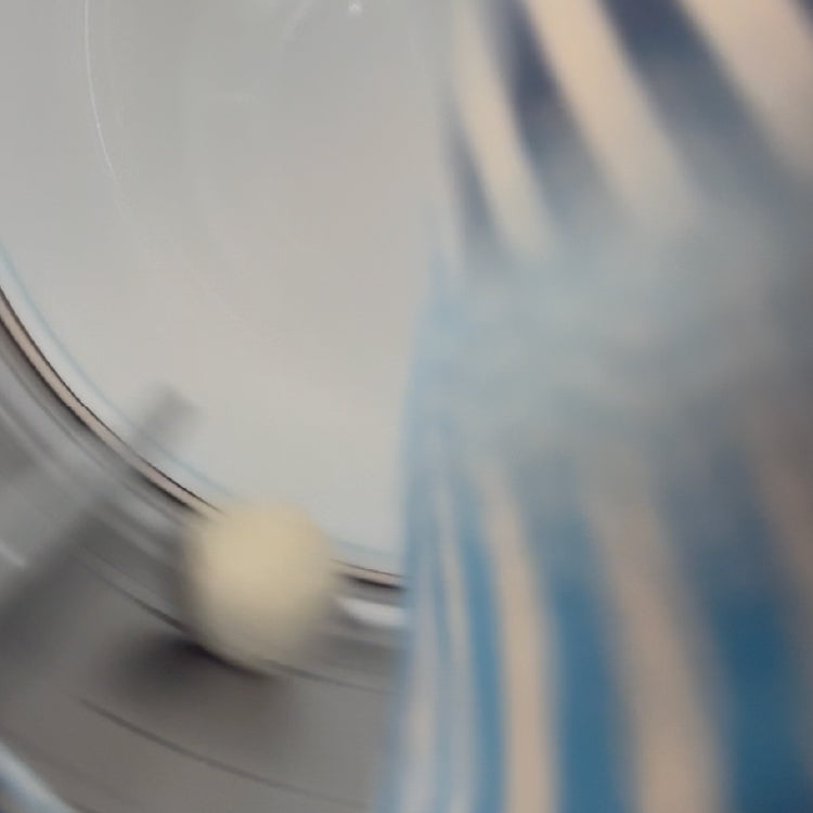 Looking inside a dryer with a tumbling blue sweater