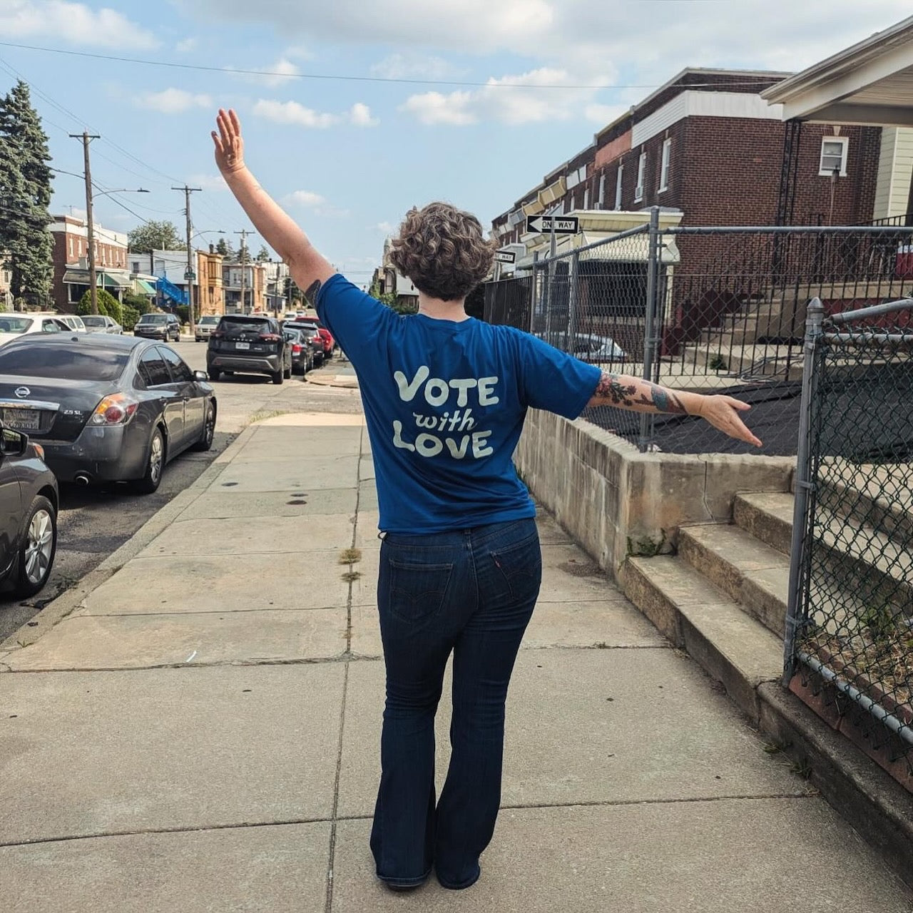 A shirt reading "Vote with Love" in custom lettering