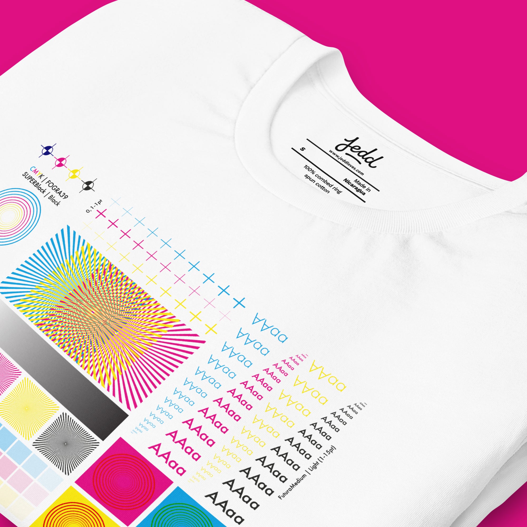 White t-shirt with colorful geometric patterns and text on a pink background