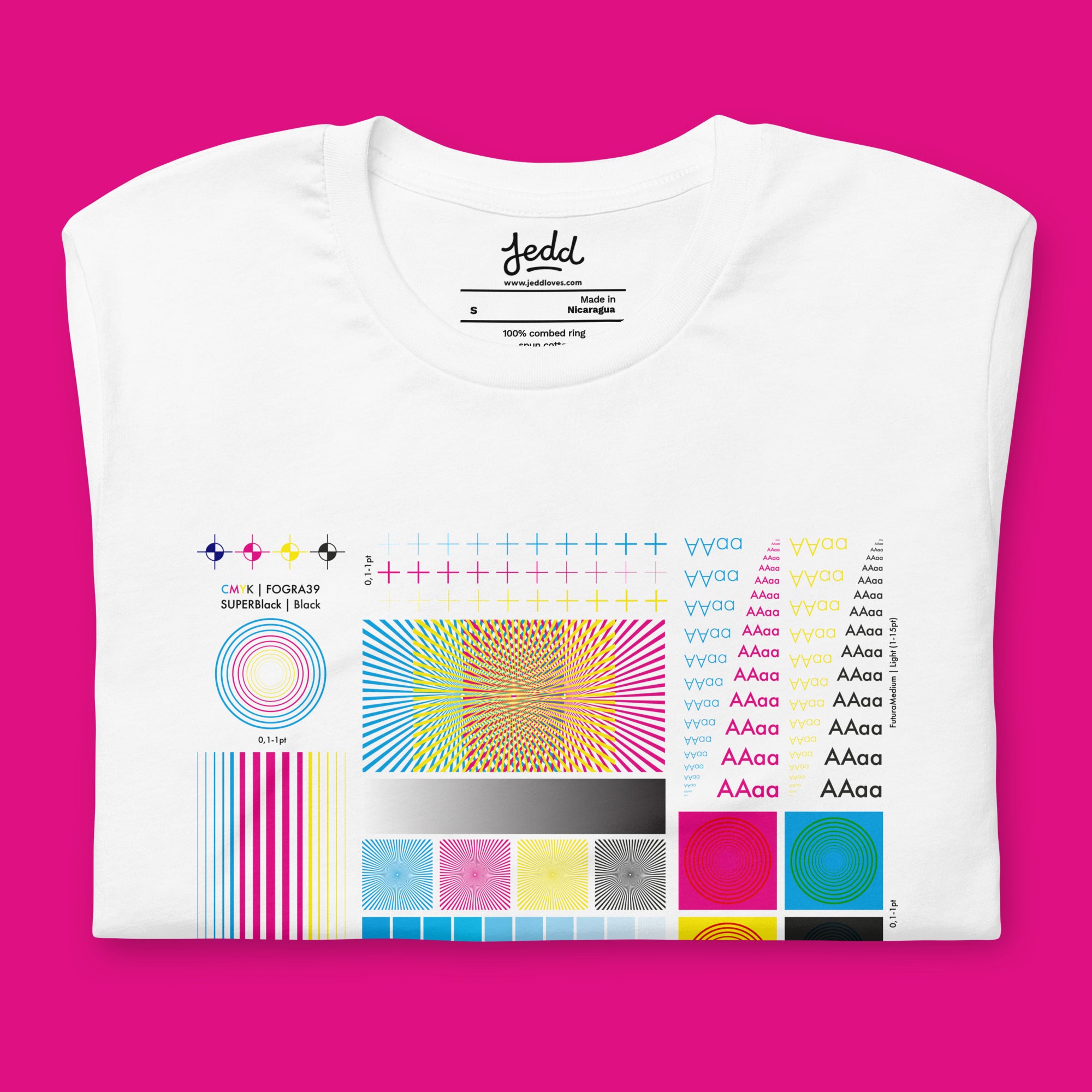 White t-shirt with colorful design on a pink background