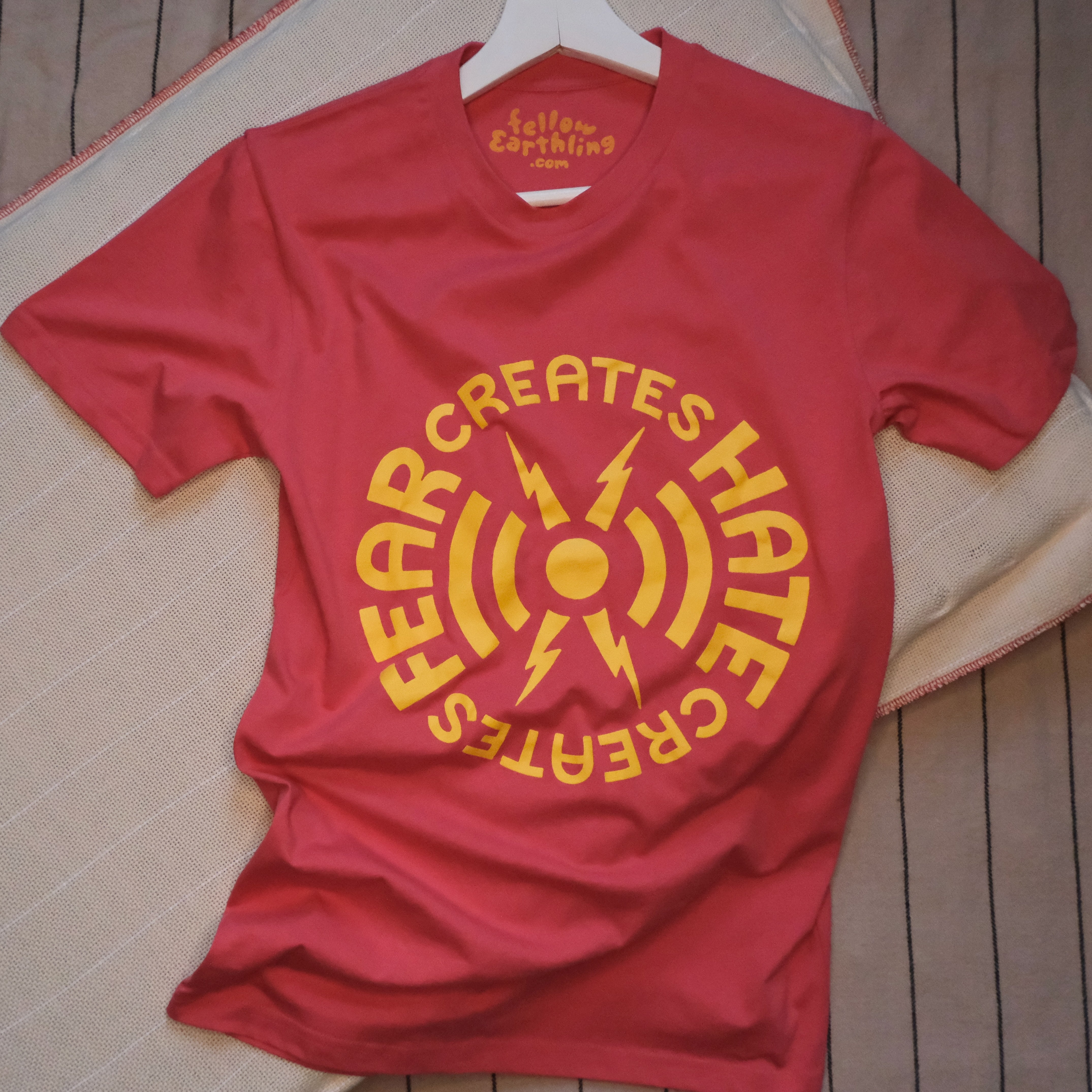 A t-shirt with a design that reads Fear Creates Hate