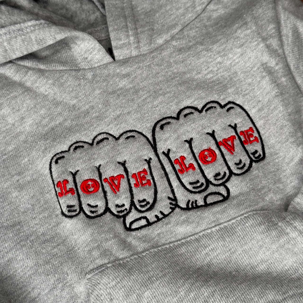 Detail of a design of two fists together that read Love Love