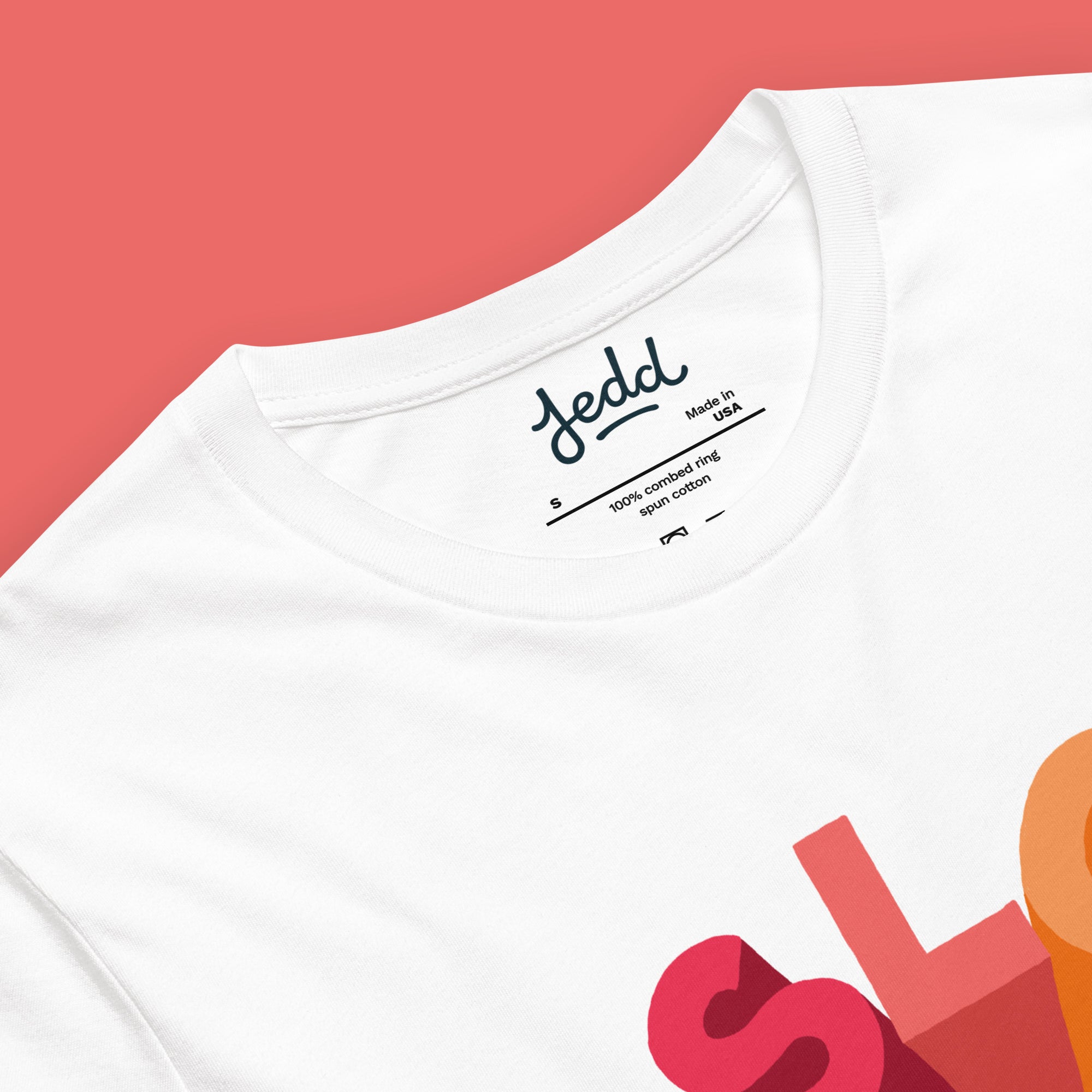 White t-shirt with colorful design and 'Jedd' branding on a red background