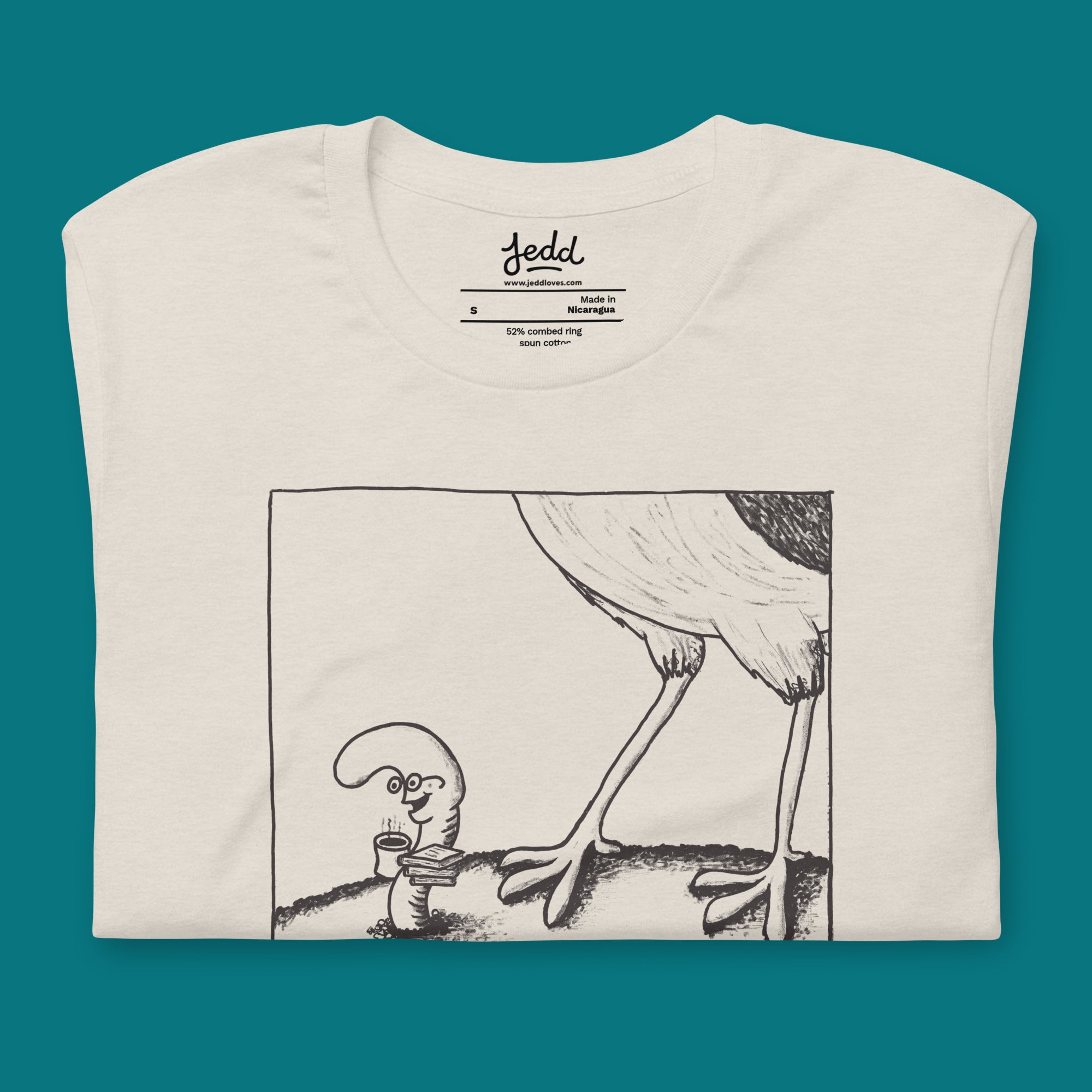 A t-shirt with a cartoon with a bird looming over a worm with a caption that says "the early worm..."