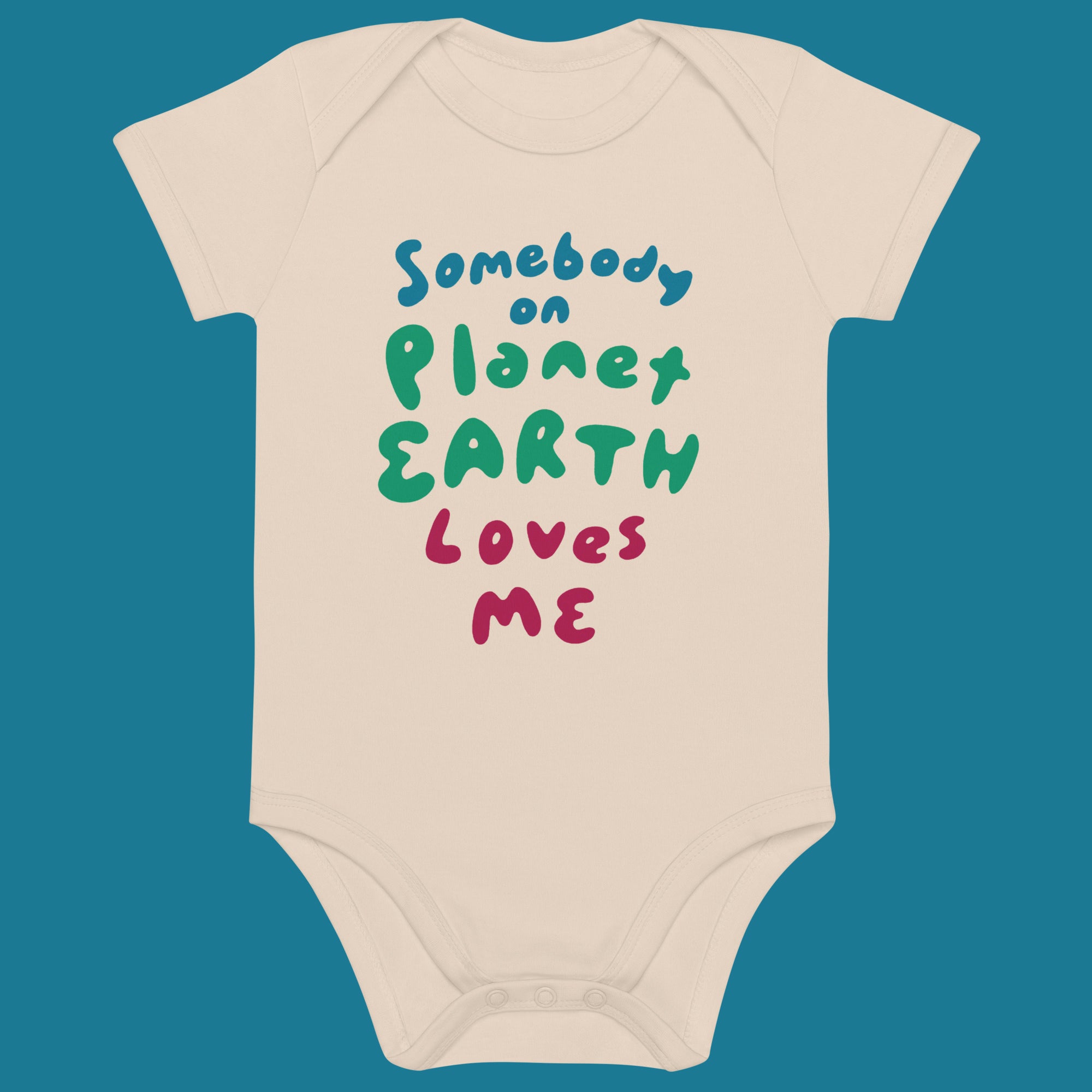 Beige baby onesie with colorful text that says Somebody on Planet Earth Loves me