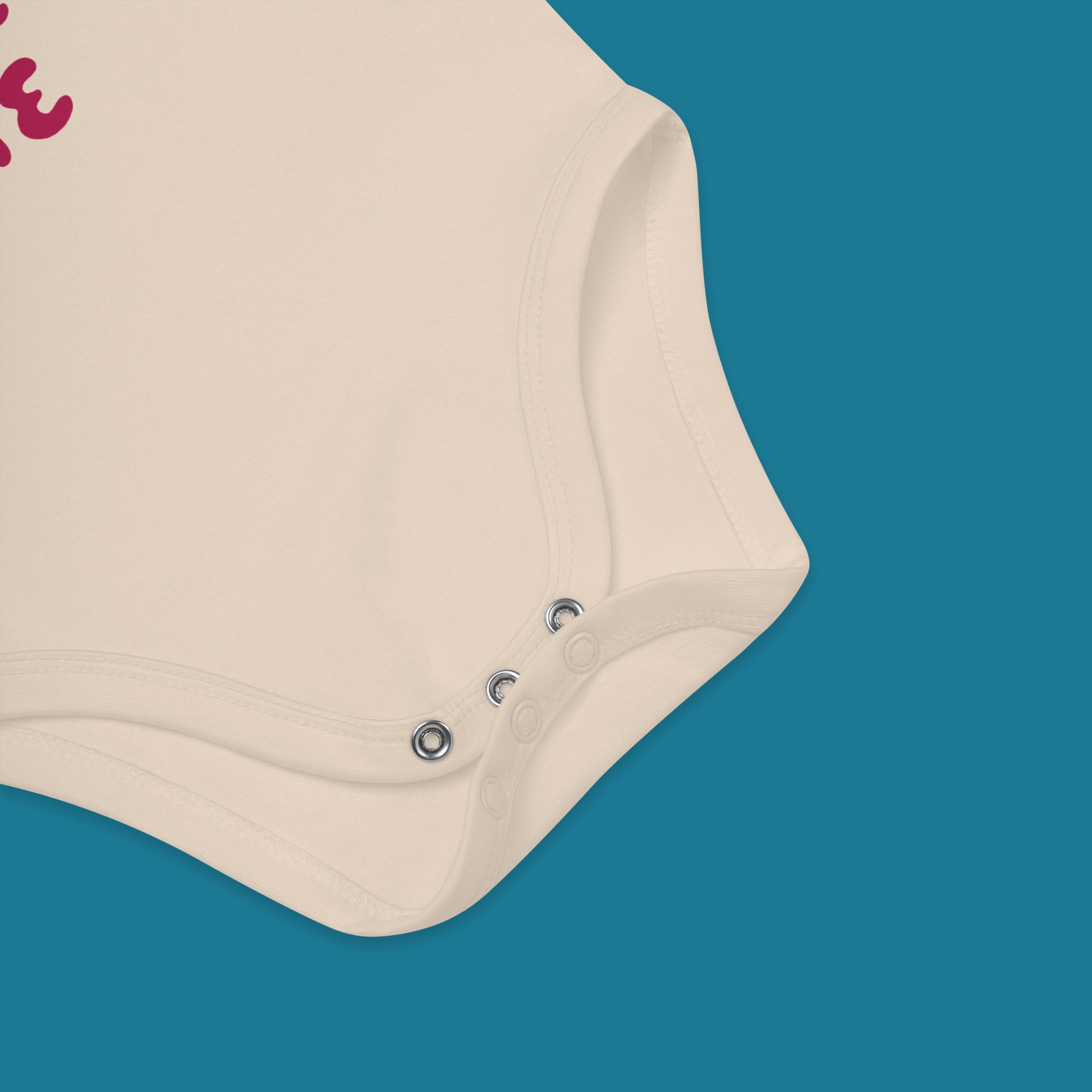 Beige baby onesie with buttons on a blue background