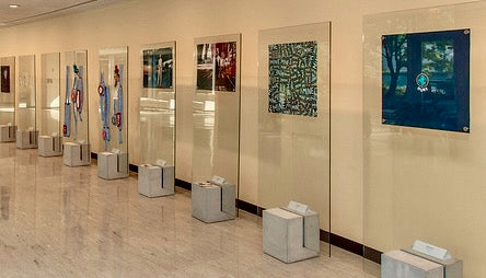 An art exhibit with Jedd's artwork picturing the planet earth in the foreground.