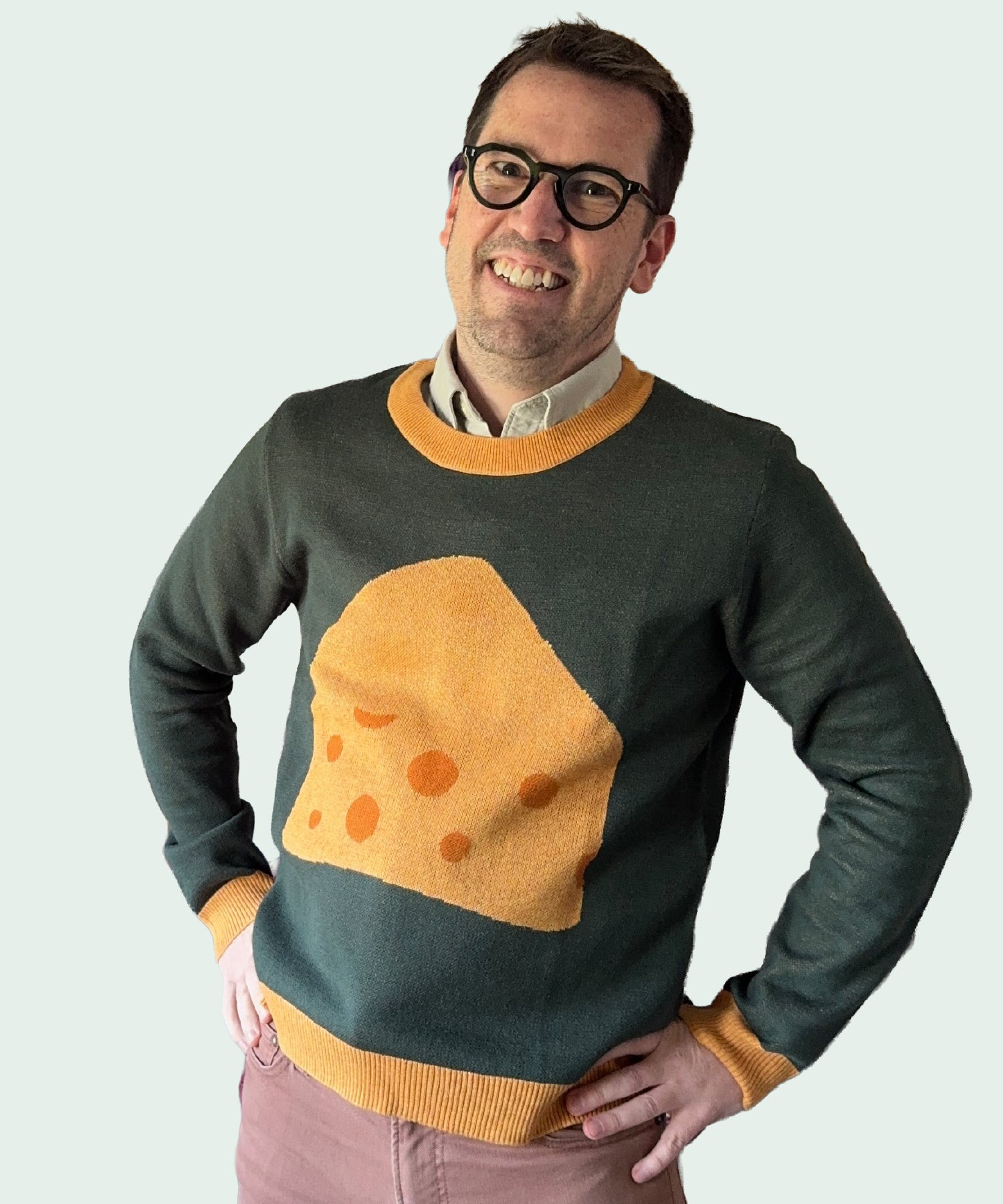 Jedd wearing a greed sweater with a block of cheese design