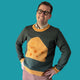 Jedd wearing a green sweater with a block of cheese design