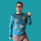 Jedd wearing a blue sweater with weather symbol designs