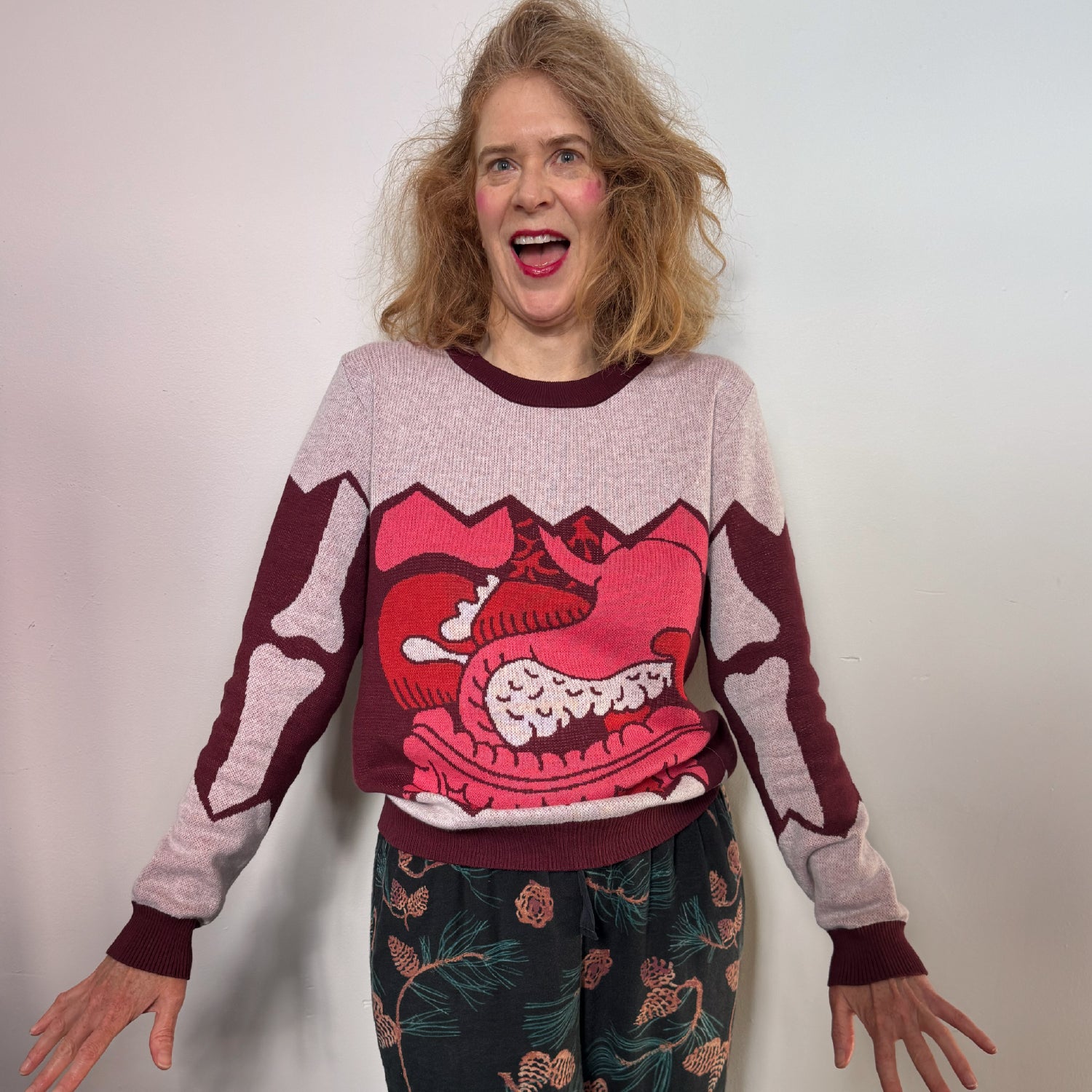 An portrait of Jedd's friend Stacey wearing a gray sweater with an illustration of guts over the stomach
