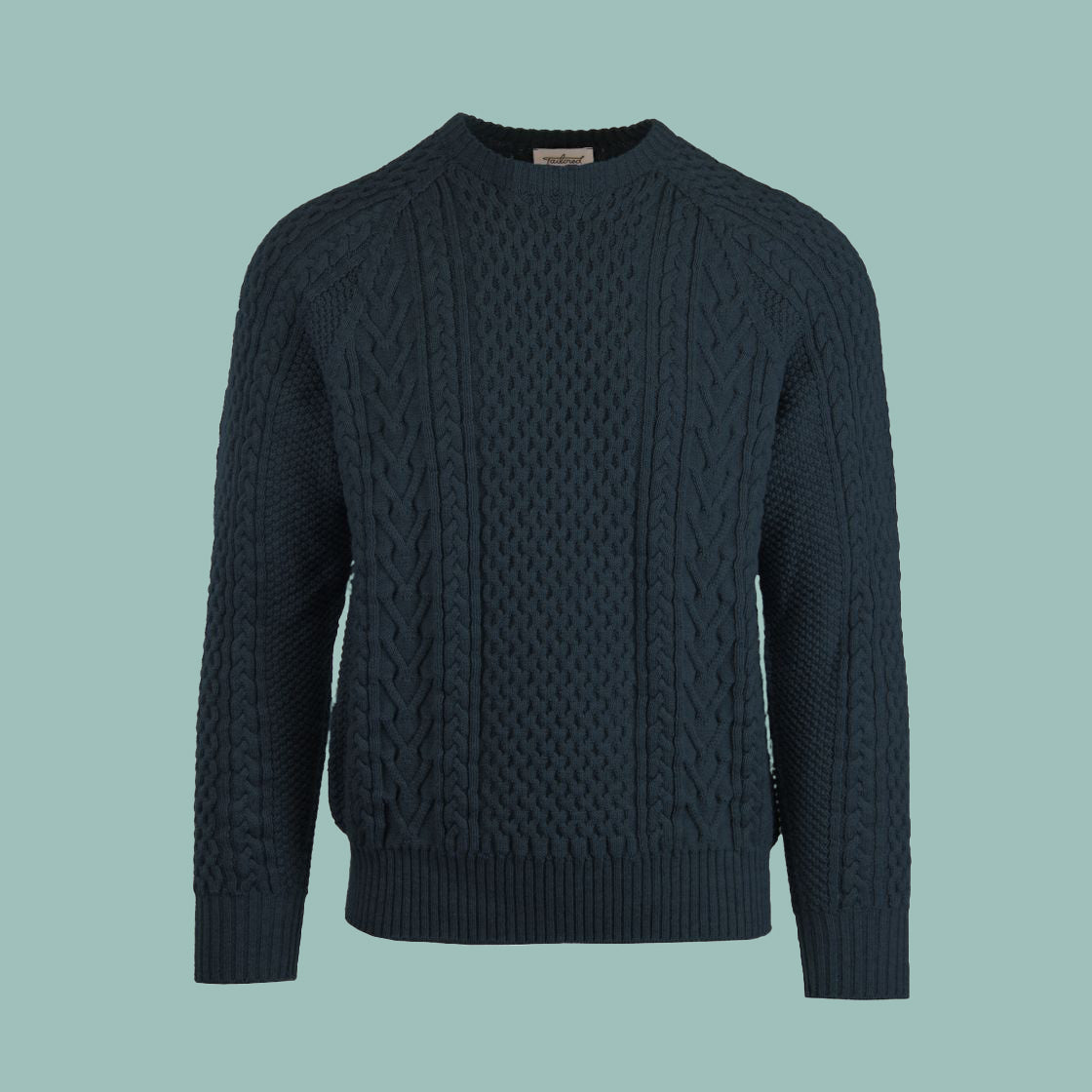 A cable-knit sweater in a deep blue marine color