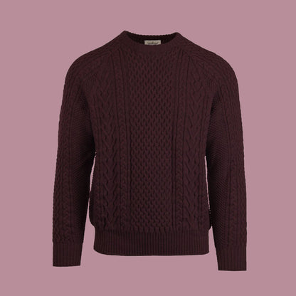 A cable-knit sweater in a dark red color