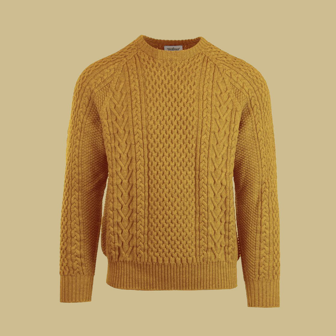 A cable-knit sweater in a yellow dijon color