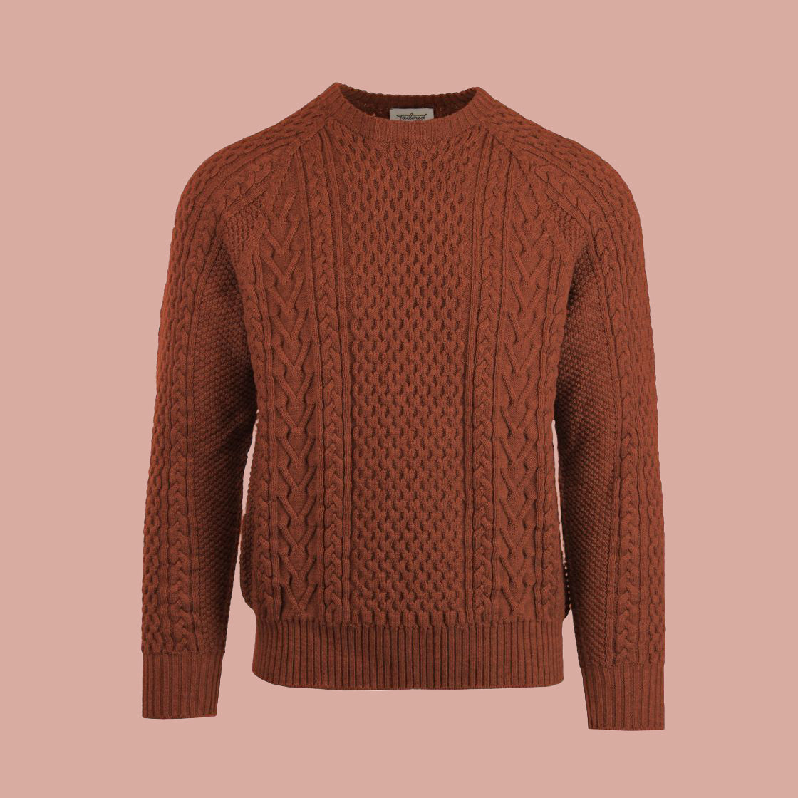 A cable-knit sweater in an orange Terra Cotta color