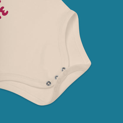 Beige baby onesie with buttons on a blue background